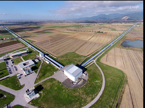Fig. 3 - Lantenna gravitazionale Virgo, a Cascina (Pisa).  formato da due bracci perpendicolari lunghi ognuno 3 km, che formano un interferometro. Riesce a misurare la distanza tra le estremit dei bracci con una precisione assolutamente incredibile: frazioni delle dimensioni di un protone. Questo  lo strumento, insieme ai due interferometri simili negli Stati Uniti (chiamati LIGO) che rivela  le onde gravitazionali.